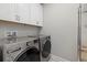 Convenient laundry room with front-load washer and dryer at 2028 Woodleaf Hammock Ct, Bradenton, FL 34211