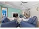 Living Room with two blue sofas, a coffee table, and a wall-mounted TV at 2028 Woodleaf Hammock Ct, Bradenton, FL 34211