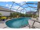 Sparkling pool with a screened enclosure and plenty of space for lounging at 2028 Woodleaf Hammock Ct, Bradenton, FL 34211