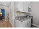 Modern wet bar with gray countertops and white cabinets at 2028 Woodleaf Hammock Ct, Bradenton, FL 34211