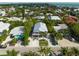 Elevated view of a beach house with lush landscaping and private driveway at 203 72Nd St, Holmes Beach, FL 34217