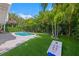 Tropical backyard with pool, putting green, and patio at 203 72Nd St, Holmes Beach, FL 34217