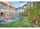 Tropical backyard oasis with pool, putting green, and patio at 203 72Nd St, Holmes Beach, FL 34217