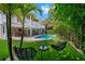 Private backyard with pool, putting green, and seating area at 203 72Nd St, Holmes Beach, FL 34217