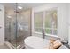 Spa-like bathroom featuring a soaking tub and a large walk-in shower at 203 72Nd St, Holmes Beach, FL 34217