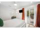 Bedroom with white bed and orange curtains, leading to the pool at 203 72Nd St, Holmes Beach, FL 34217