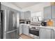 Bright kitchen featuring stainless steel appliances and gray cabinets at 203 72Nd St, Holmes Beach, FL 34217