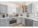 Spacious kitchen with gray cabinets, white backsplash, and ample counter space at 203 72Nd St, Holmes Beach, FL 34217