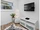 Living area with white TV stand, floor lamp, and zebra rug at 203 72Nd St, Holmes Beach, FL 34217