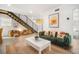 Modern living room with green sofa and white coffee table at 203 72Nd St, Holmes Beach, FL 34217