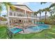 Inviting pool area with lounge chairs, putting green, and patio at 203 72Nd St, Holmes Beach, FL 34217