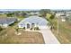 White house with gray roof, driveway, and landscaped yard in a residential area at 2053 Rio De Janeiro Ave, Punta Gorda, FL 33983