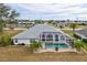 Aerial view of house with pool and screened enclosure at 2053 Rio De Janeiro Ave, Punta Gorda, FL 33983