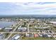 Aerial view of community with lake and businesses at 2053 Rio De Janeiro Ave, Punta Gorda, FL 33983