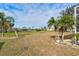 Large backyard with grassy area and palm trees at 2053 Rio De Janeiro Ave, Punta Gorda, FL 33983