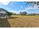 Large backyard with lush lawn and distant neighborhood views at 2053 Rio De Janeiro Ave, Punta Gorda, FL 33983