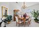 Bright dining room with a wooden table, chandelier, and decorative plants at 2053 Rio De Janeiro Ave, Punta Gorda, FL 33983