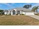 Single story home with a grey roof, white exterior, and a neatly landscaped yard at 2053 Rio De Janeiro Ave, Punta Gorda, FL 33983