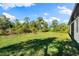 Expansive grassy backyard with mature trees at 2133 Selover Rd, North Port, FL 34287