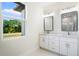 Modern bathroom with double vanity and large window at 2133 Selover Rd, North Port, FL 34287