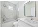 Clean bathroom with white vanity, marble shower, and a modern mirror at 2133 Selover Rd, North Port, FL 34287