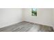 Bright bedroom with gray vinyl flooring and a window at 2133 Selover Rd, North Port, FL 34287