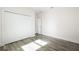 Bright bedroom with gray vinyl flooring and white closet doors at 2133 Selover Rd, North Port, FL 34287