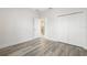 Bedroom with gray flooring, white closet doors, and a view into the kitchen at 2133 Selover Rd, North Port, FL 34287