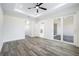 Large bedroom with sliding glass doors to patio and grey floors at 2133 Selover Rd, North Port, FL 34287