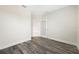 Spacious bedroom with door to another room and grey floors at 2133 Selover Rd, North Port, FL 34287