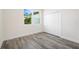 Bright bedroom with grey wood-look floors and large closet at 2133 Selover Rd, North Port, FL 34287