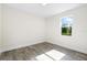 Spacious bedroom featuring gray vinyl flooring and a window at 2133 Selover Rd, North Port, FL 34287