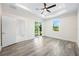 Primary bedroom with sliding glass doors to patio and ceiling fan at 2133 Selover Rd, North Port, FL 34287