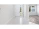 Bright entryway with white tile floor and view into another room at 2133 Selover Rd, North Port, FL 34287