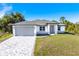 Newly constructed home with gray roof and paver driveway at 2133 Selover Rd, North Port, FL 34287