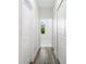 Bright hallway with wood-look floors and access to rooms at 2133 Selover Rd, North Port, FL 34287