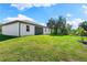 Back exterior view of the house and backyard at 2133 Selover Rd, North Port, FL 34287