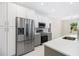 Modern kitchen with stainless steel appliances and white cabinets at 2133 Selover Rd, North Port, FL 34287