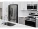 Stainless steel appliances and white shaker cabinets at 2133 Selover Rd, North Port, FL 34287