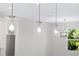 Clear glass pendant lights above kitchen island at 2133 Selover Rd, North Port, FL 34287