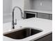 Modern kitchen sink and faucet with white quartz countertop at 2133 Selover Rd, North Port, FL 34287