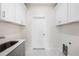 Laundry room with white cabinets and gray countertop at 2133 Selover Rd, North Port, FL 34287