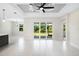 Bright living room with tile floors and sliding glass doors leading to backyard at 2133 Selover Rd, North Port, FL 34287