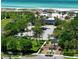 Beach club, parking lot, and beach access with lush landscaping at 2195 Harbourside Dr # 404, Longboat Key, FL 34228