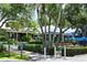 Community clubhouse with outdoor seating and lush landscaping at 2195 Harbourside Dr # 404, Longboat Key, FL 34228