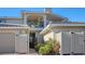 Exterior view of two-story home with landscaped yard and two car garage at 2195 Harbourside Dr # 404, Longboat Key, FL 34228