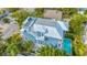 Elevated view showcasing a blue home, private pool, and rooftop deck at 2213 Avenue B, Bradenton Beach, FL 34217