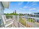 Relaxing balcony with white rocking chairs and neighborhood views at 2213 Avenue B, Bradenton Beach, FL 34217