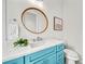 Stylish bathroom with teal vanity and a modern toilet at 2213 Avenue B, Bradenton Beach, FL 34217