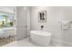 Elegant bathroom with a freestanding tub and marble flooring at 2213 Avenue B, Bradenton Beach, FL 34217